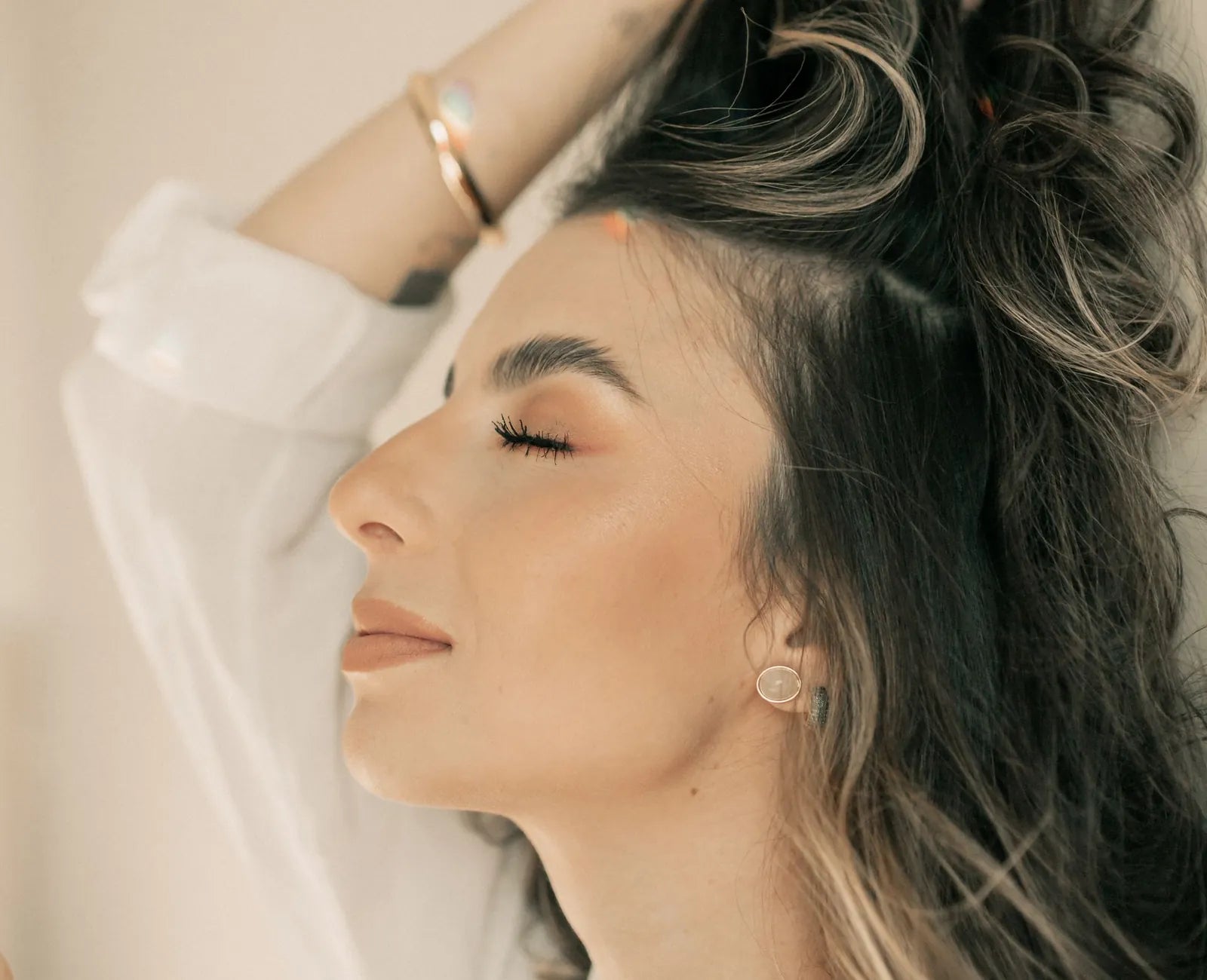 Woman relaxing in warm sunlight, eyes closed